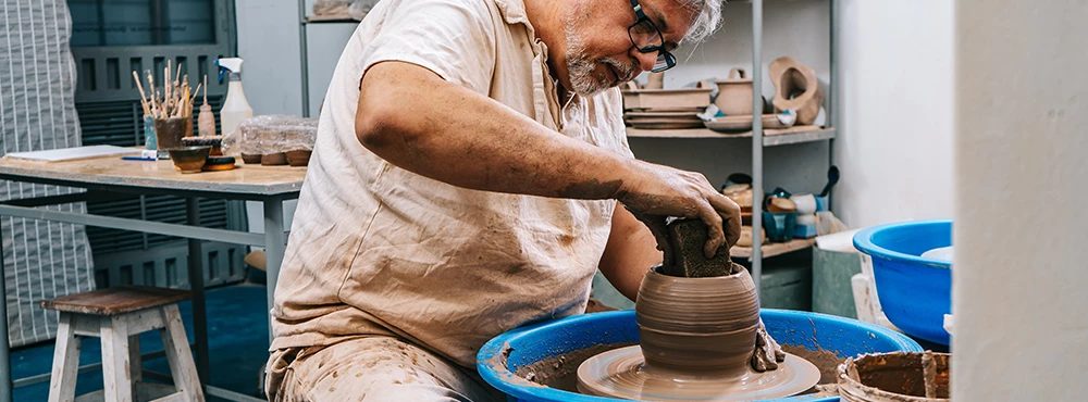 male potter working